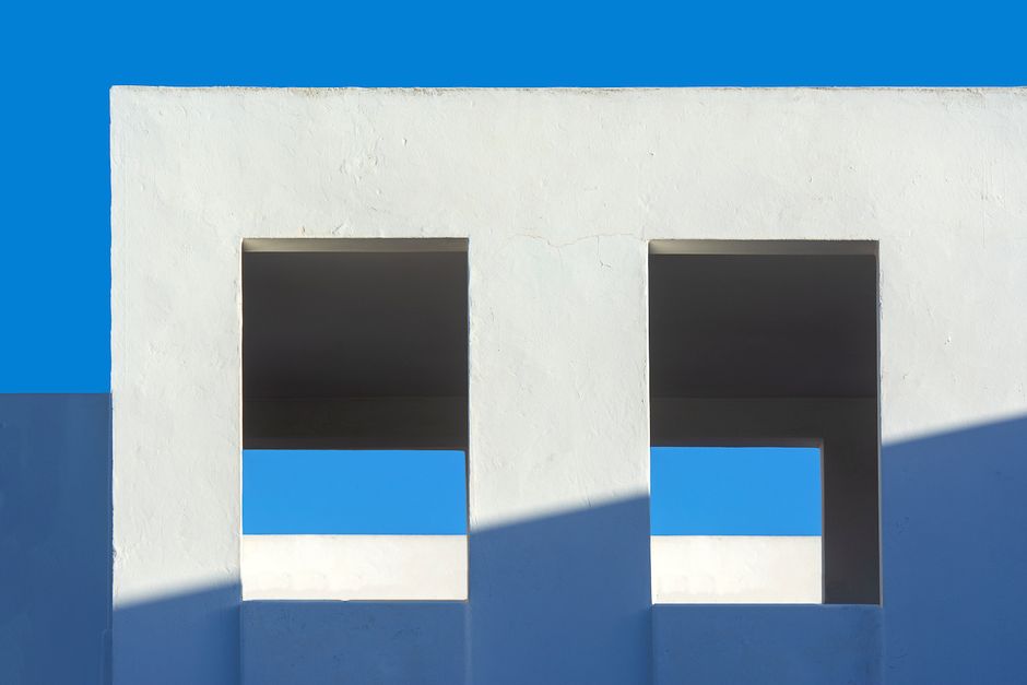 View looking up at a modern building with clean, minimalist architectural lines against a clear sky, symbolizing growth and future-proofing a law firm.
